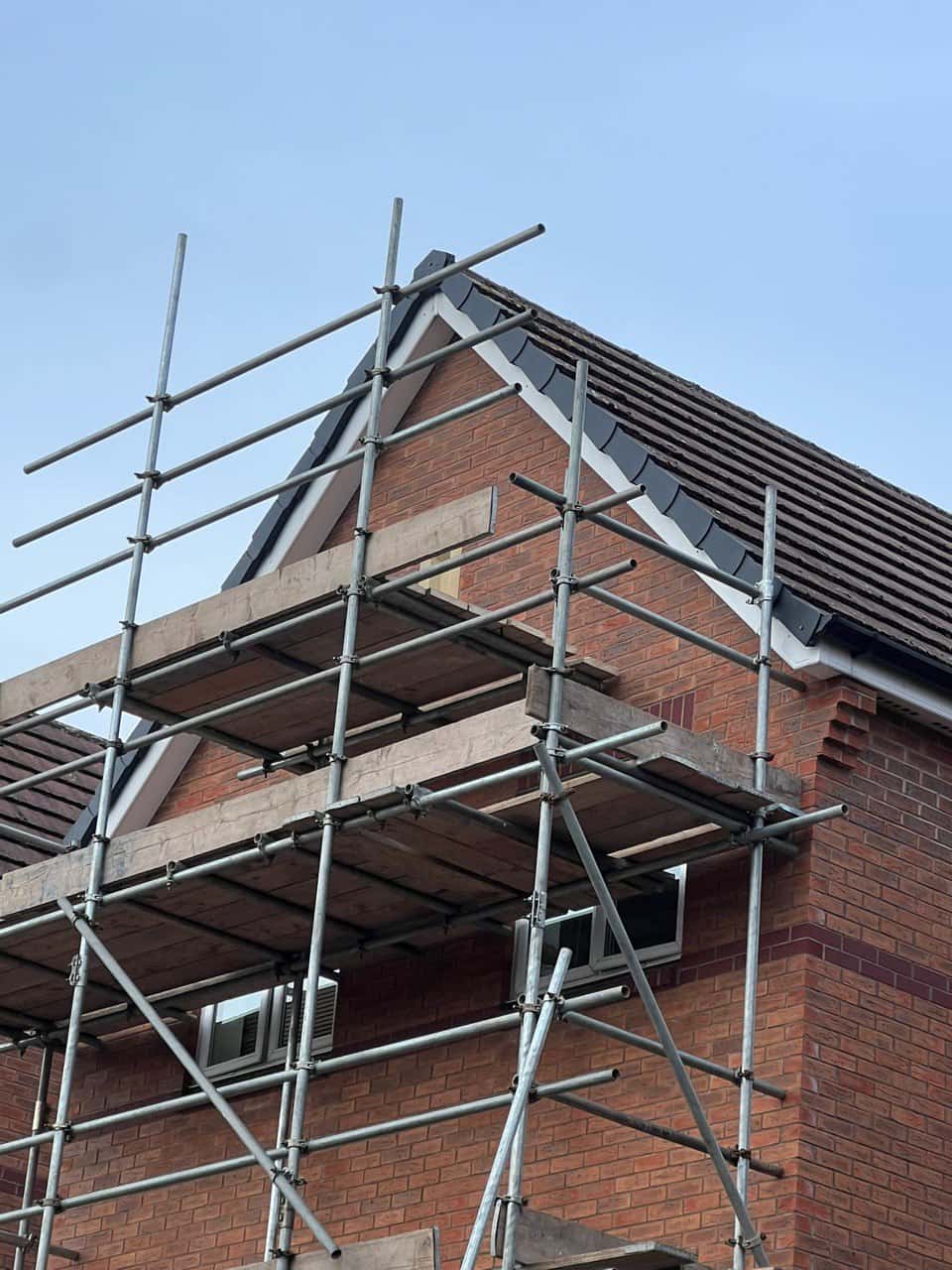 This is a photo of a roof which has just been repaired. There is a scaffold located at the gable end for access onto the roof. Works carried out by Havant Roofing Repairs