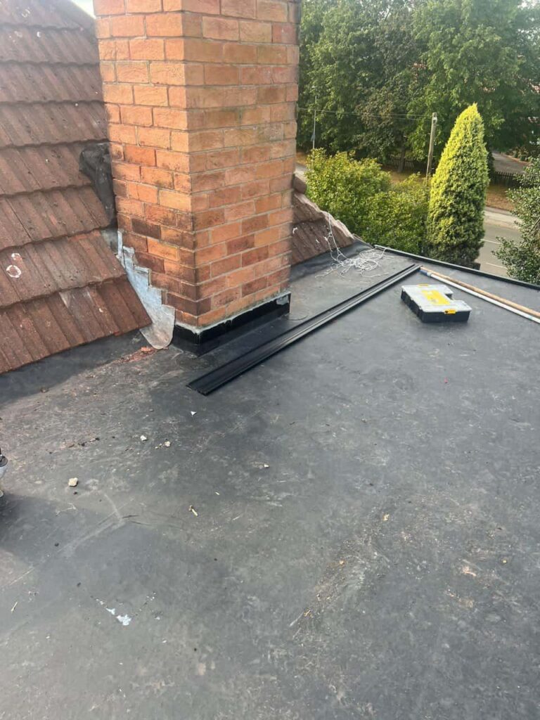 This is a photo of a flat roof which has just been repaired, there is also a chimney stack and some leadwork has also been dressed. Works carried out by Havant Roofing Repairs