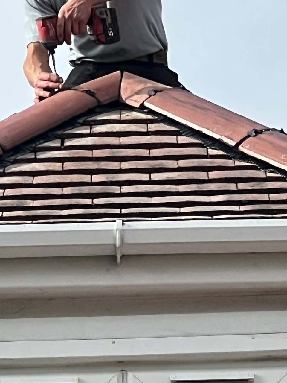 This is a photo of one of the operatives of Havant Roofing Repairs installing new ridge tiles